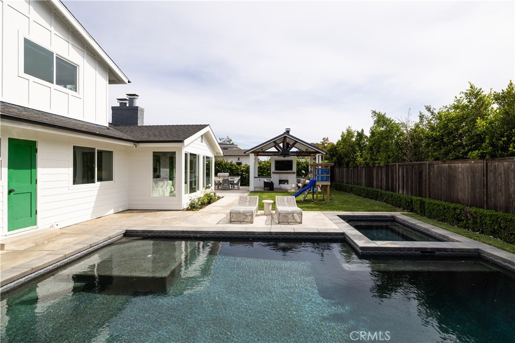 1609 Ruth Lane Newport Beach, CA 92660 - Photo 30 of 39 a view of swimming pool with lounge chair and dinning table under an white umbrella