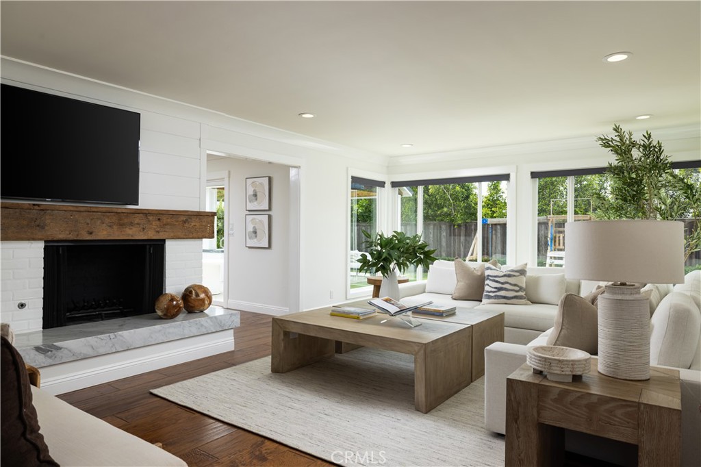 1609 Ruth Lane Newport Beach, CA 92660 - Photo 3 of 39 a living room with furniture a fireplace and a flat screen tv