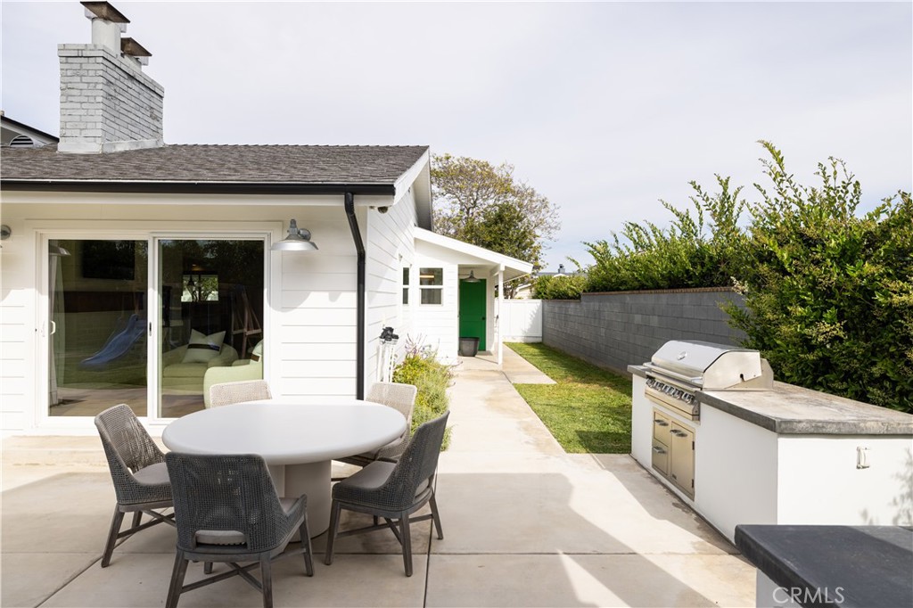 1609 Ruth Lane Newport Beach, CA 92660 - Photo 36 of 39 a view of a patio with table and chairs with wooden fence and plants