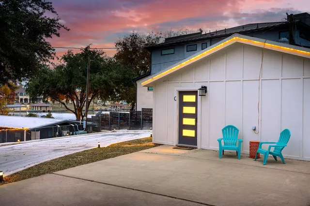 a kitchen with stainless steel appliances granite countertop a refrigerator a sink dishwasher a stove and white cabinets with wooden floor