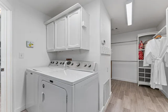 a bedroom with a bed and a flat tv screen in it