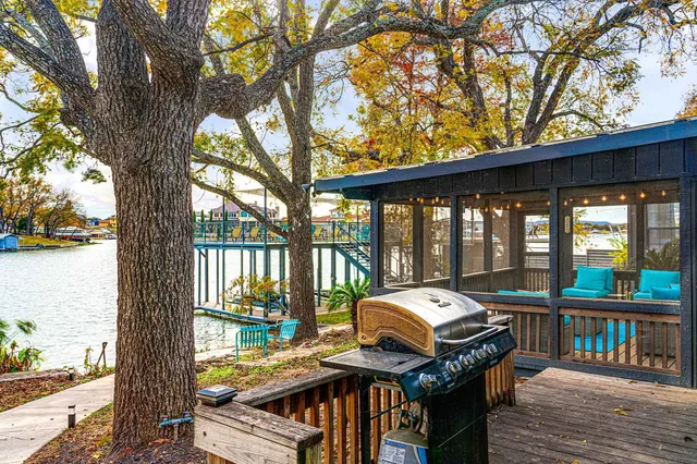 a car parked on a wooden deck next to a yard