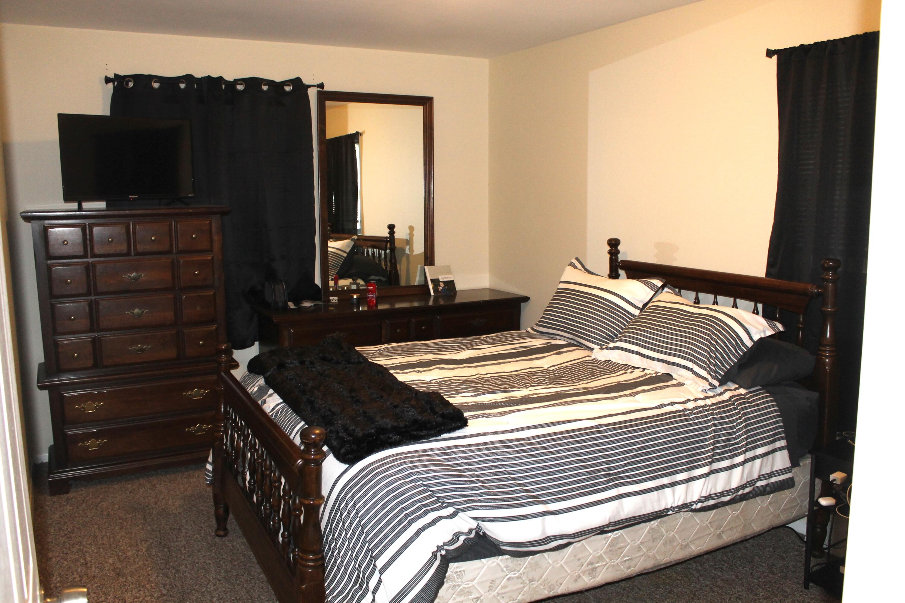 1113 Carnation Street Southeast De Motte, IN 46310 - Photo 4 of 7 a bedroom with a bed and flat screen tv