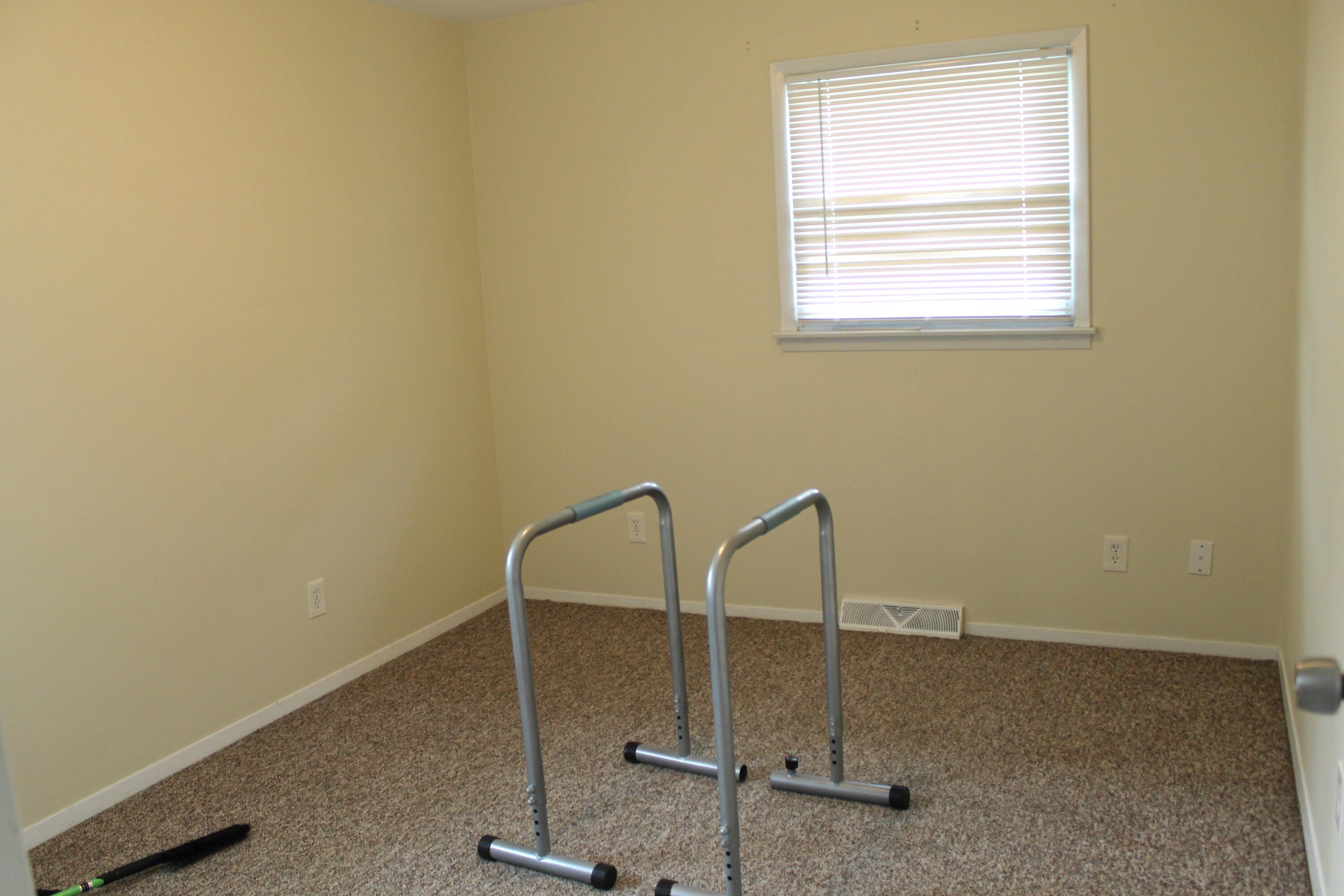 1113 Carnation Street Southeast De Motte, IN 46310 - Photo 5 of 7 a room with a wooden floor and a window