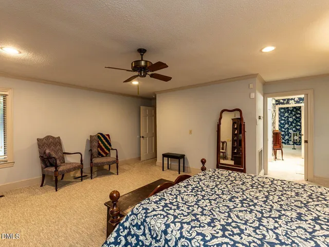 a view of a room with a window and a chair