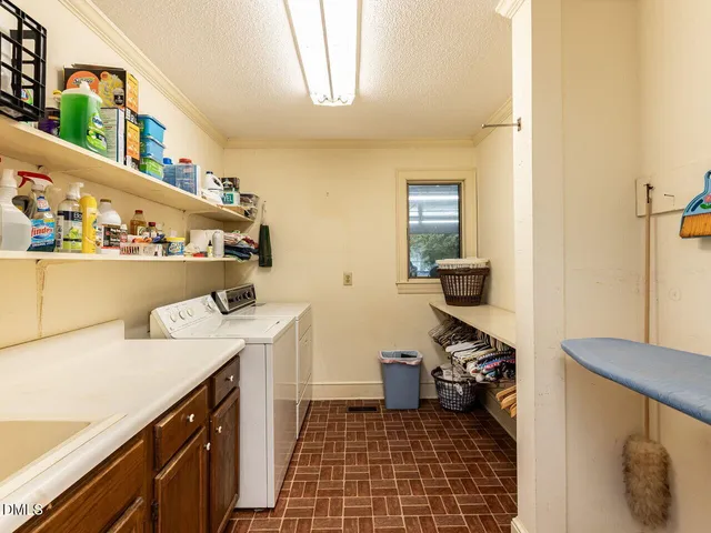 an empty room with wooden floor and natural light