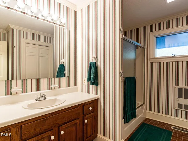 a large living room with stainless steel appliances granite countertop a couch wooden floor and a view of living room