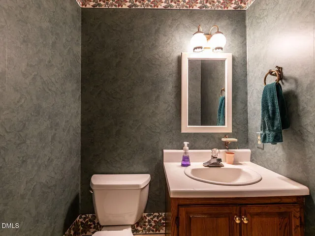 a living room with lots of furniture and kitchen view
