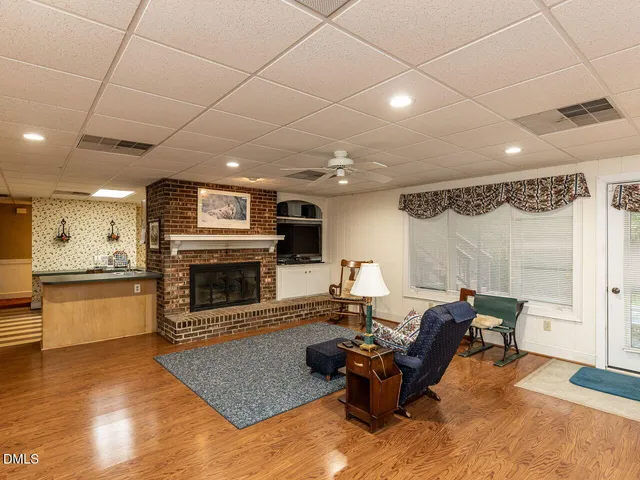 an aerial view of residential house with parking and trees