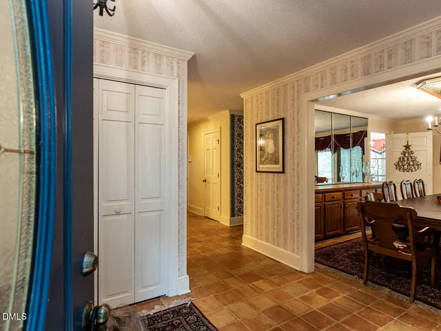 a kitchen with stainless steel appliances granite countertop a sink a stove a refrigerator and island with wooden floor