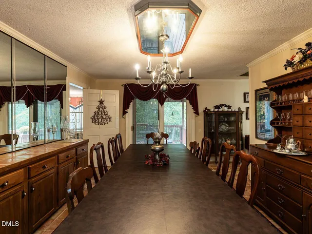 a view of a dining room with furniture and chandelier