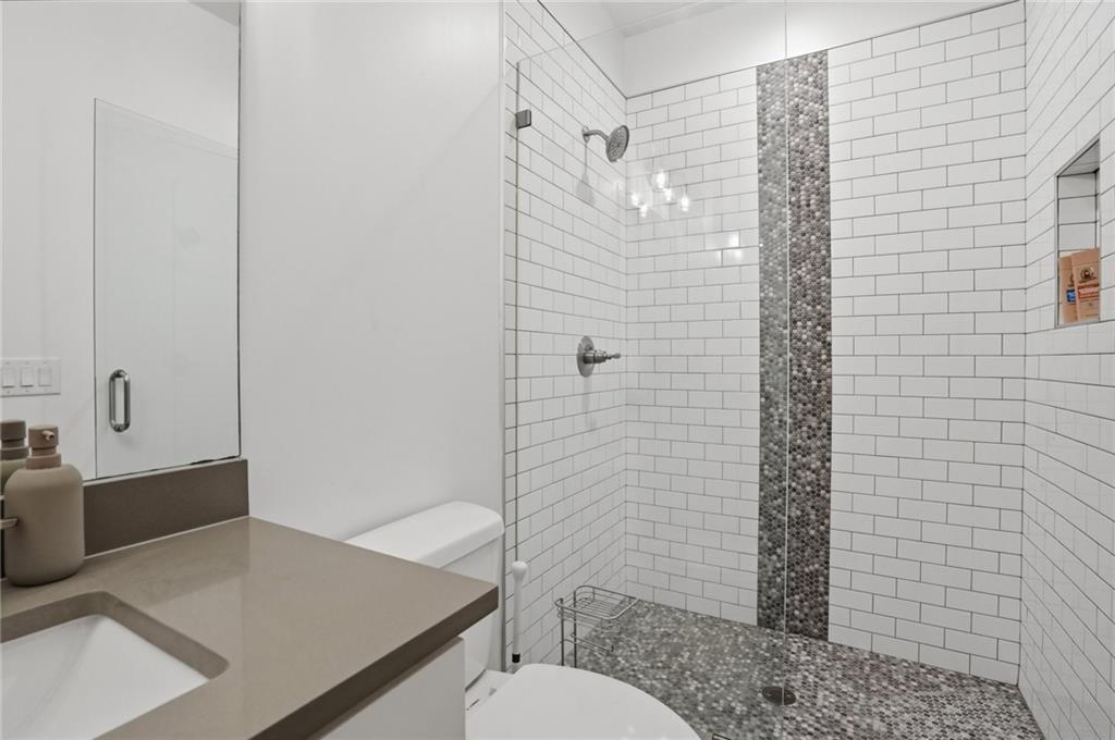 3020 Wallace Road Buford, GA 30519 - Photo 45 of 66 a bathroom with a sink toilet and shower