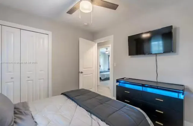 a bedroom with a bed and a flat screen tv