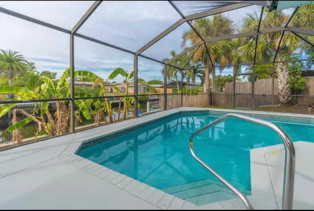 a view of swimming pool with a patio and a yard