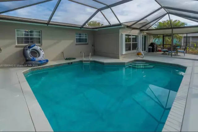 a backyard of a house with table and chairs