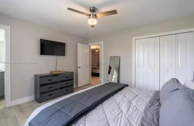 a bedroom with a bed and a flat screen tv