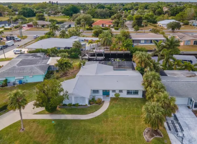 an aerial view of multiple houses with yard