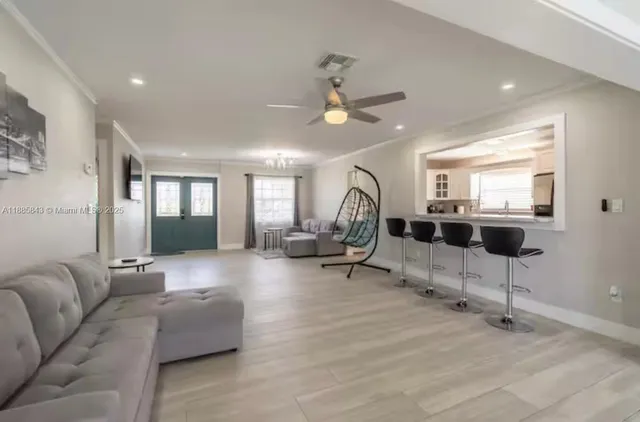 a living room with furniture a dining table and a fireplace