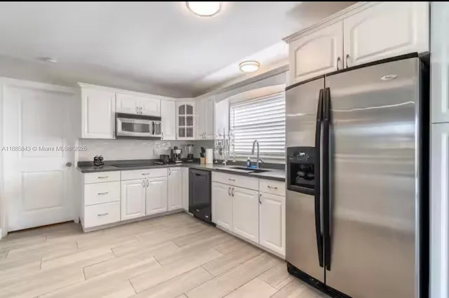 a kitchen with a refrigerator stove and sink