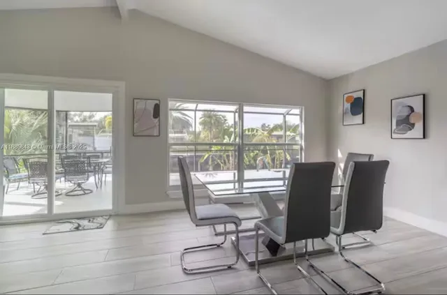a view of a work space with wooden floor and a floor to ceiling window