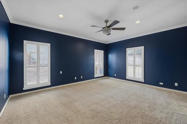 a view of an empty room with window and closet area