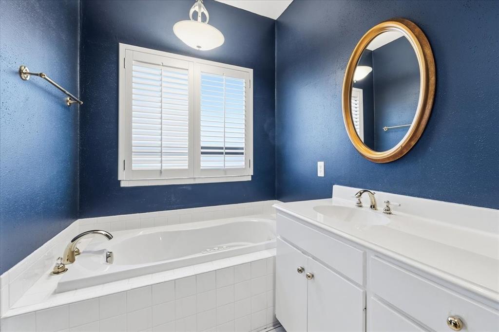 22 1 Main Place Benbrook, TX 76126 - Photo 27 of 40 a bathroom with a bathtub a sink and a mirror