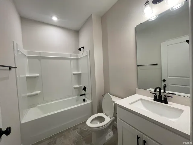 a bathroom with a sink a toilet and a bathtub