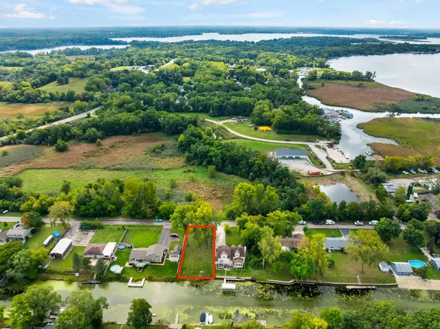 an aerial view of residential houses with outdoor space and swimming pool