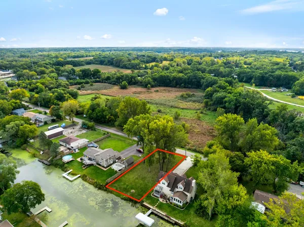 an aerial view of a residential houses with outdoor space and street view