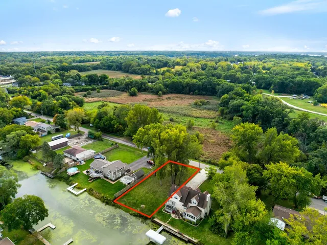 an aerial view of a residential houses with outdoor space and street view