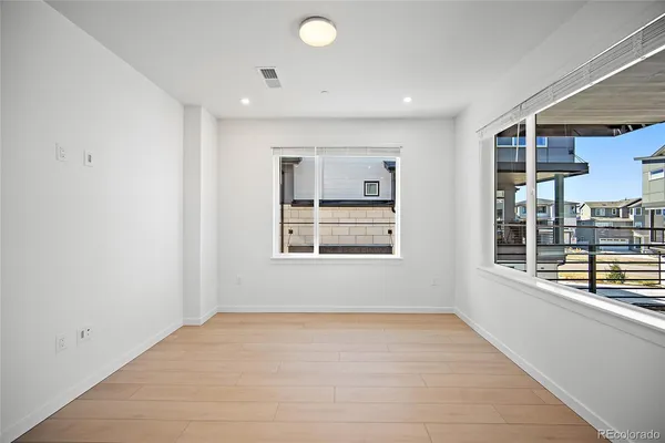 a view of kitchen with stainless steel appliances refrigerator oven and cabinets
