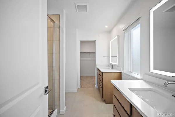 a bathroom with a granite countertop toilet and a shower