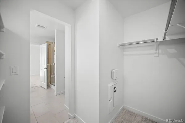 a view of a hallway with wooden floor and entryway