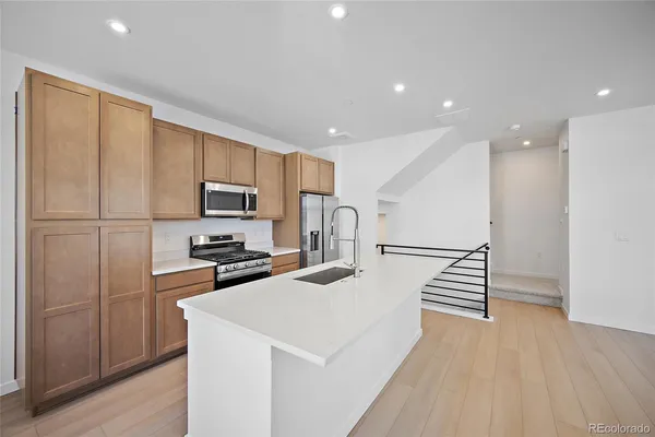 a kitchen with stainless steel appliances granite countertop a stove and a sink