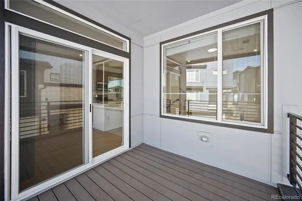 an empty room with a window and wooden floor