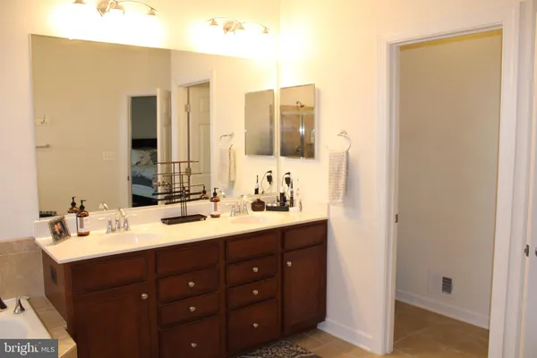 a bathroom with a double vanity sink mirror and double