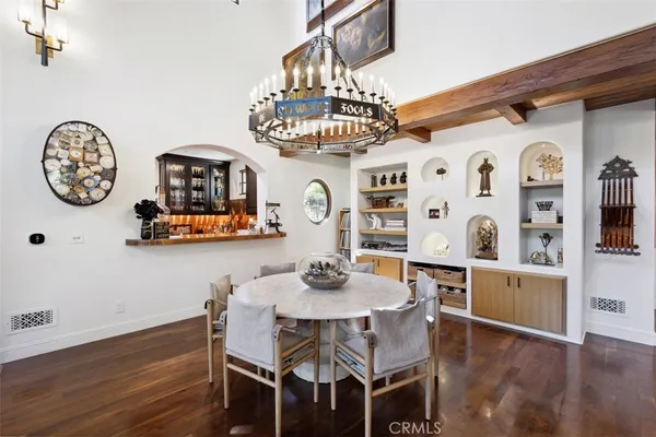 a dining room with furniture and wooden floor