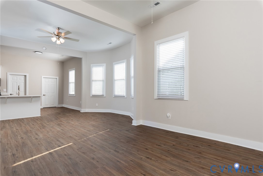 9800 Golf Course Drive Disputanta, VA 23842 - Photo 11 of 19 wooden floor in an empty room with a window