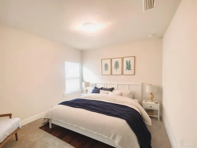 a bedroom with a bed and a window