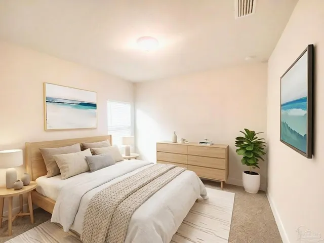 a spacious bedroom with a bed and a potted plant