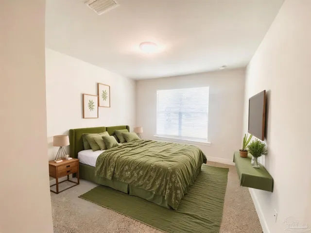 a bedroom with a bed and a potted plant