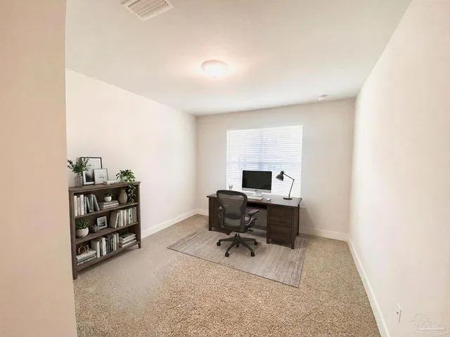 a view of a workspace with furniture