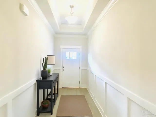 a view of hallway with furniture and a window