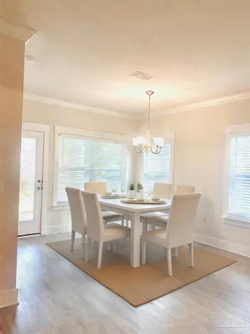 a view of a dining room with furniture and wooden floor