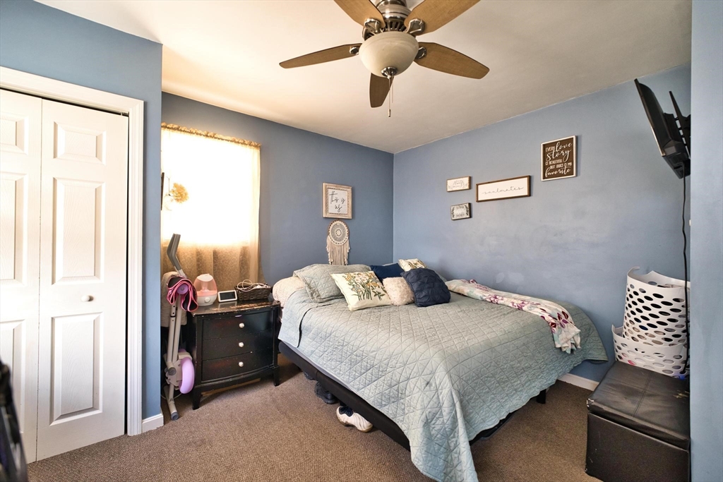 232 Alden Street Fall River, MA 02723 - Photo 25 of 34 a bedroom with a bed and a chandelier