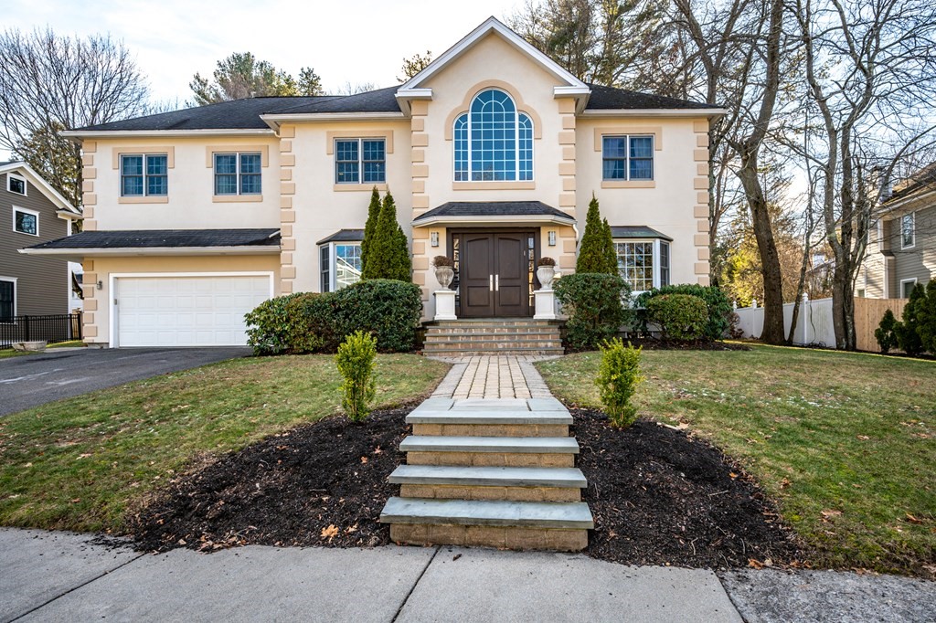 18 Fox Hill Road Newton, MA 02459 - Photo 1 of 37 a front view of a house with a garden and plants