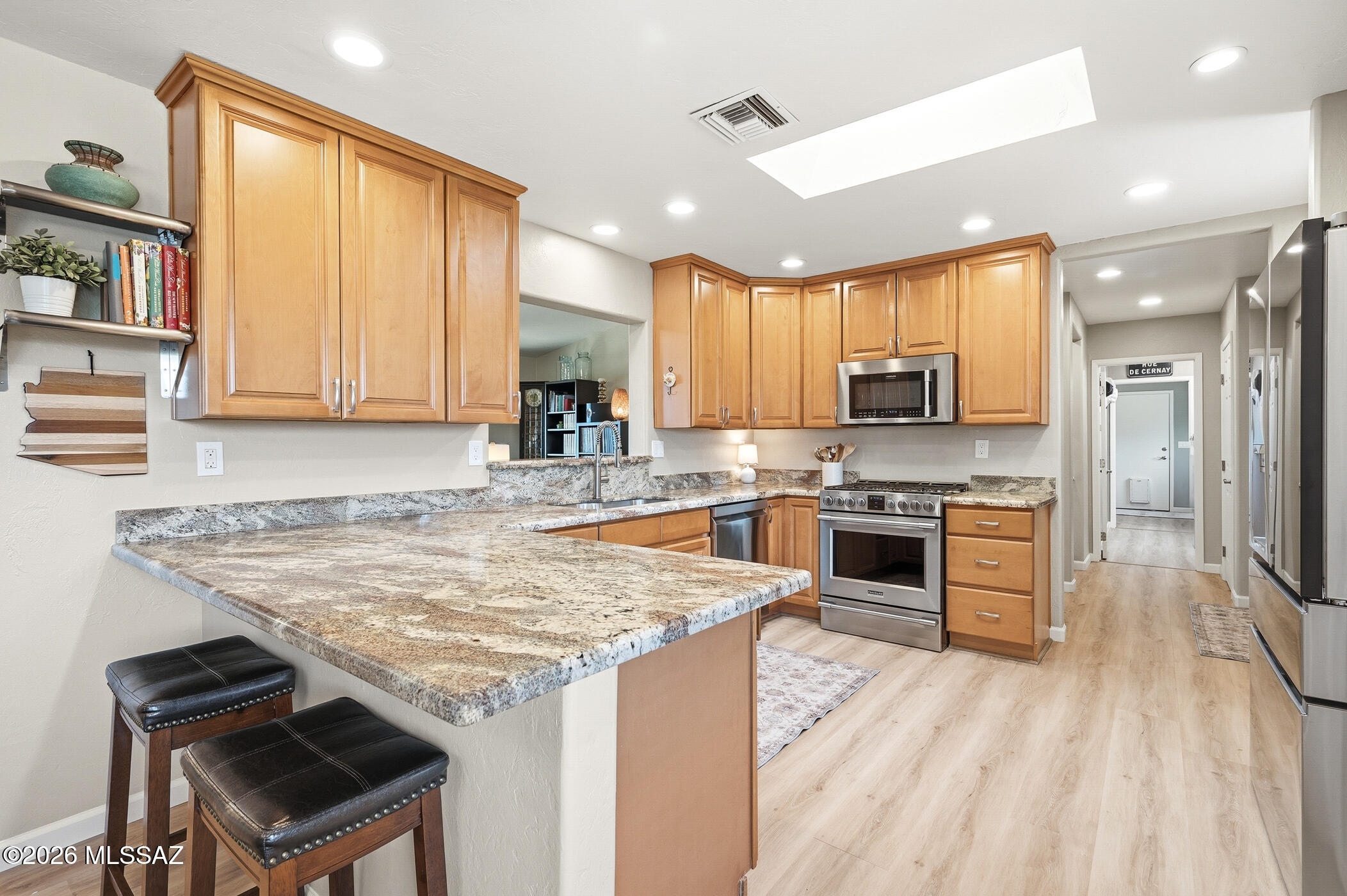 13599 East Rincon Ranch Road Vail, AZ 85641 - Photo 17 of 41 a kitchen with stainless steel appliances granite countertop a stove refrigerator and a sink