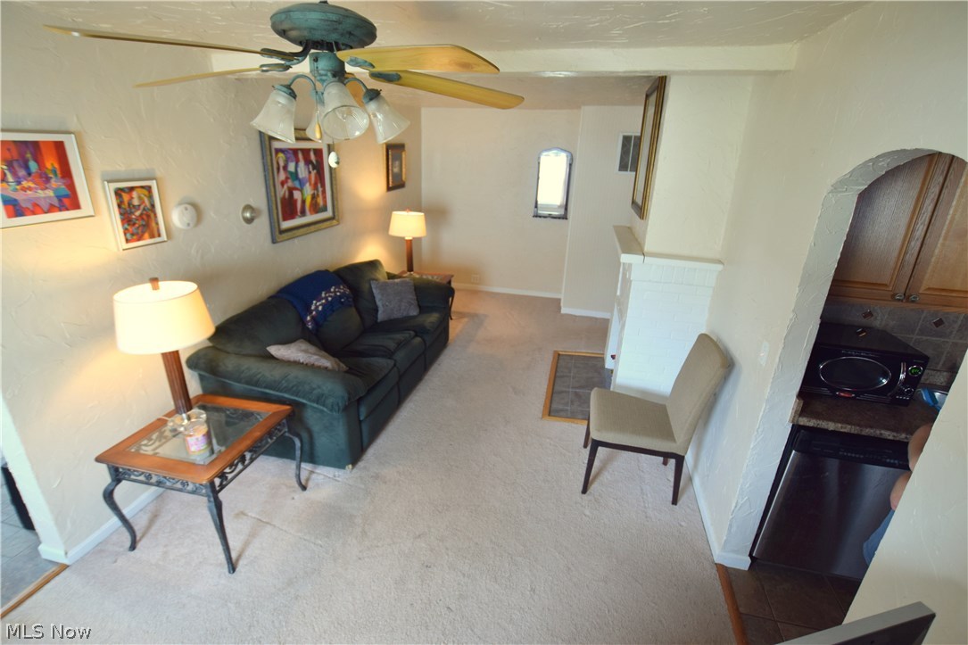 Living Room with arched doorways into front room (currently dining area) and kitchen.