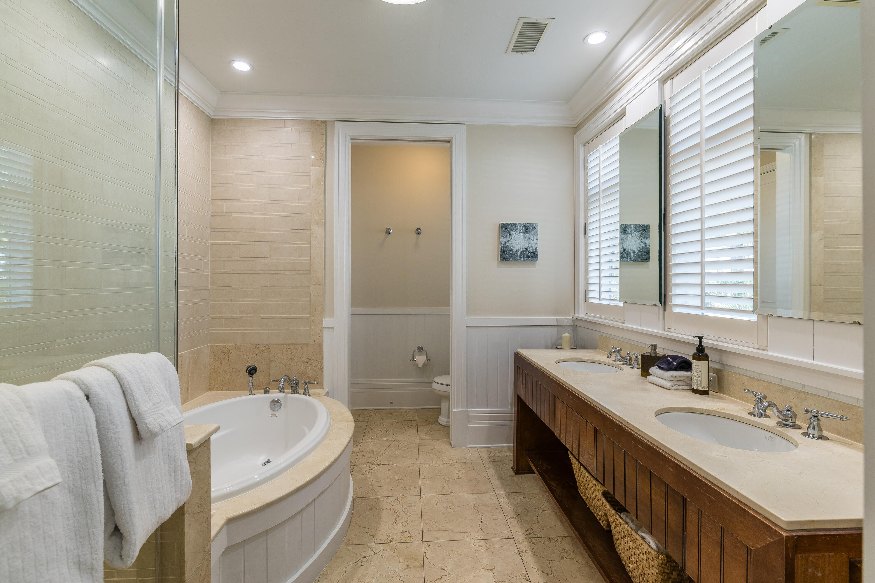 8104 Inspiration Drive, Unit C1 Miramar Beach, FL 32550 - Photo 12 of 29 a bathroom with a double vanity sink double mirror and a bathtub