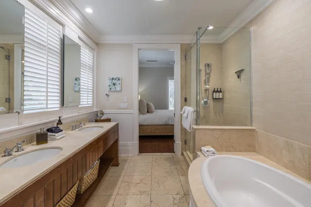 a spacious bathroom with a tub sink and mirror